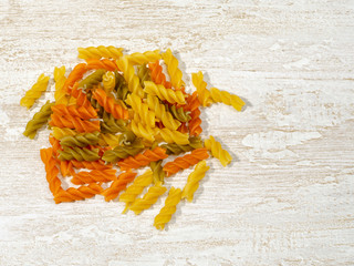 multi-colored pasta scattered on the kitchen table.