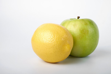 Perfect fresh green Apple with lemon isolated on a white background in full depth of field with a cropped trajectory.