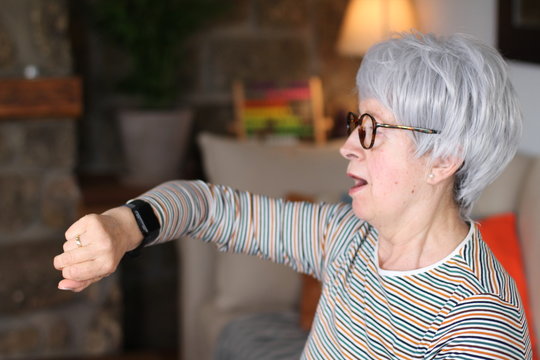 Surprised Senior Woman Looking At Watch