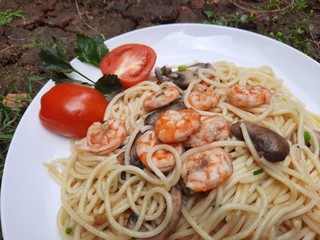 Home made spaghetti with tomato sauce, prawns, and mushrooms