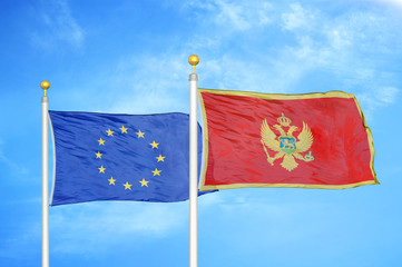 European Union and Montenegro two flags on flagpoles and blue cloudy sky