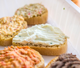 buffet of croutons with assorted flavors, mushrooms, liver, herbs, zucchini, lard, tomato, chilli pepper, sausage, cheese