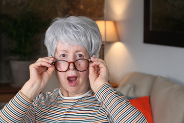 Shocked senior woman with eyeglasses