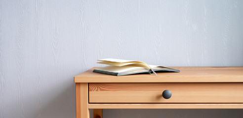 A book on a stylish wooden table. Beautiful interior