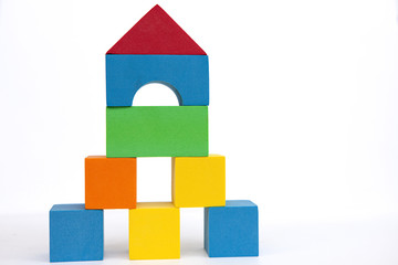Obraz premium A toy house made of colored cubes. A house made of blocks on a white background.