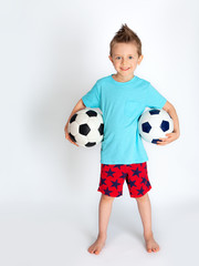 boy domestic football player with two full-length balls on a white background