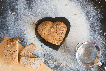 Heart shape of wholemeal bread on blackboard