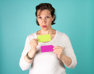 Woman holding two blank note tags up with room for your copy.