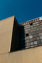 Old industrial building with steel and glass on blue sky