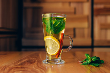 glass of tea with a lemon mint and 
cinnamon