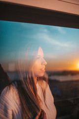 Young woman behind a window
