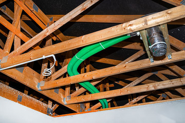 Home energy recovery ventilation, visible system of green flexible pipes and air supply diffuser,...