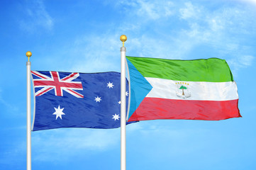 Australia and Equatorial Guinea two flags on flagpoles and blue cloudy sky