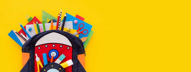 Backpack with school notebooks. Back to school creative concept.
