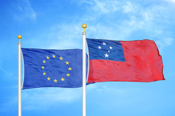 European Union and Samoa two flags on flagpoles and blue cloudy sky