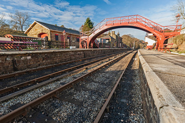 Fototapeta na wymiar Train tracks at an old station platform