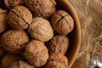 Walnuts kernels in wooden bowl, Walnut healthy food Top view