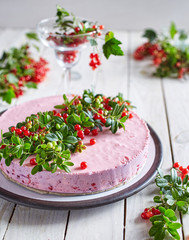 Yogurt cake with berries on a white wooden board surface