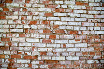 Old red and white ruined brick wall