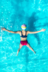 girl swims in a blue pool