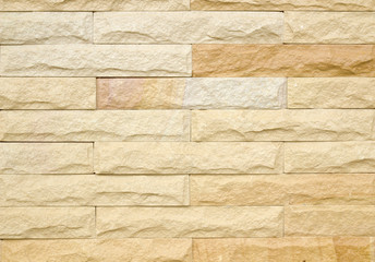 Texture of golden sandstone bricks background