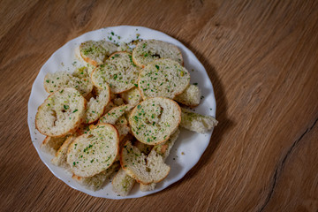 A plate with delicious snacks for beer and TV shows in the form of a fried loaf with spices. Snacks for the time of self-isolation.