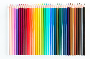 Crayons and watercolor pastels lined up isolated