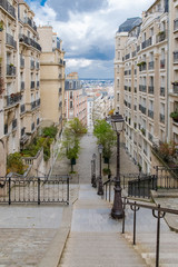 Obraz premium Paris, romantic staircase in Montmartre, typical buildings and floor lamp 