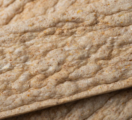 Extruded rye bread macro texture background