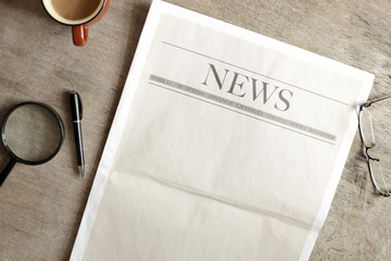 Newspaper and coffee on wooden background