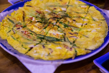 Korean savory seafood and scallions pan-fried pancake, Pajeon, on a big plate.