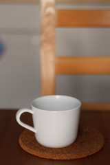 Obraz premium white mug against the kitchen background on the table with a blurred background. composition kitchen