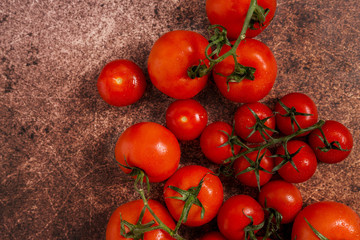 Free space with different kind of red tomatoes at old rusty dark background