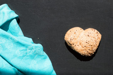 Heart shape of wholemeal bread on blackboard