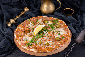 Lahmajut with nuts baked in oven and served with greens and lemon