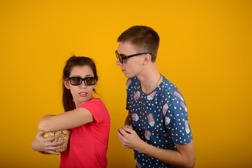 young couple with popcorn in cinema