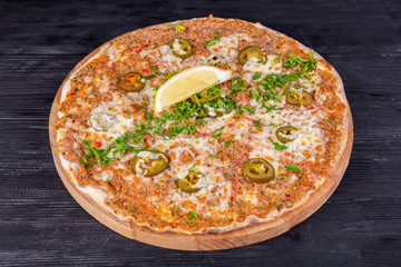 Lahmajut with nuts baked in oven and served with greens and lemon
