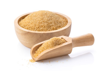 brown sugar in wood scoop and bowl on white background