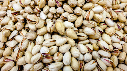 Roasted and salted pistachios in a shell (texture, background)