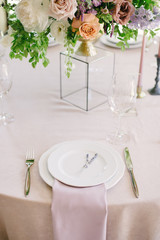 Table setting at a luxury wedding and Beautiful flowers on the table.