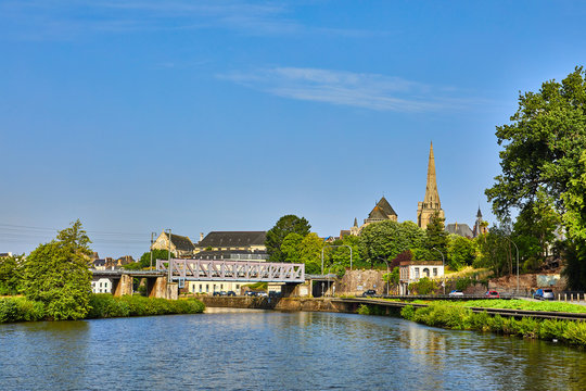 Image of Redon approached from the river vilaine with the church steeple and viaduct bridge.