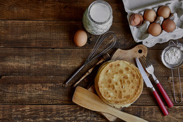 Preparing fresh pancakes on the dark wooden table