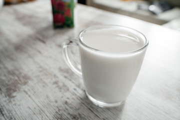 Mug with yogurt on a light background close-up