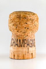 Close up of the cork from a bottle of champagne. The word "Champagne" has been burnt onto the side of the cork.