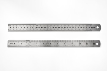 Stainless metal rulers on white background