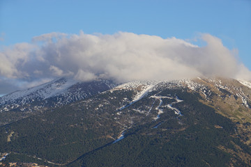 mountain landscape with clouds at dusk in the Pyrénées, France with a small ski resort