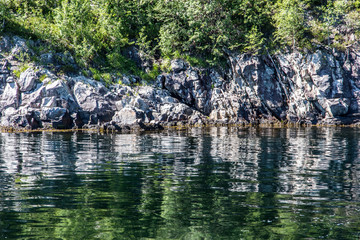 Obraz na płótnie Canvas Typical scandinavian rocks and green water