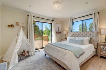 Beautiful bedroom interior with luxury natural decor details, childrens beige bedroom with linen grey white bed.