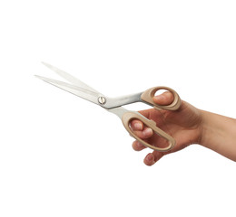 female hand holds big metal tailor scissors, object isolated on white background