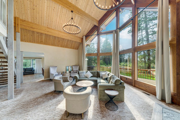 Grant huge living room with grant fireplace and three sotry tall windows in an amazing luxury room...